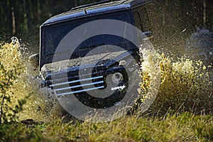 Extreme, challenge and 4x4 vehicle concept. Car racing in autumn forest. Offroad race on fall nature background. SUV or