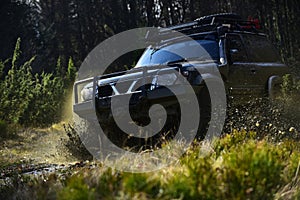 Extreme, challenge and 4x4 vehicle concept. Offroad race on nature background. Car racing in forest. SUV or offroad car