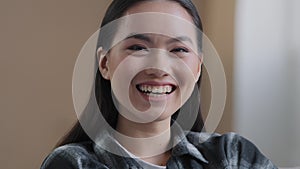 Extreme close-up Asian girl portrait woman with perfect white toothy smile looking at camera laughing at funny joke
