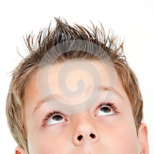 Extreme close up of boy looking up.