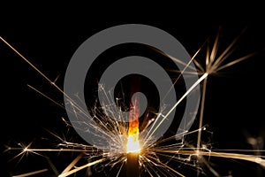 Extreme close-up of a burning sparkler with black background photo