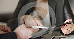 Extreme close up of business woman`s hands using tablet computer