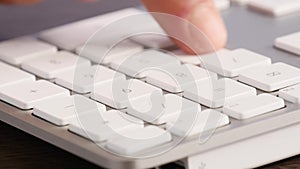 Extreme close -up businessman typing keypad