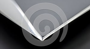 Close-up of a sharp, brushed metal edge against a dark background