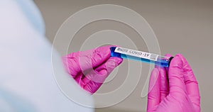 Extreme Close up of Covid-19 Sample Tube in Hands