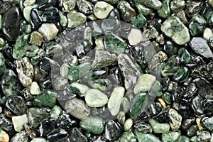 Extreme close up of dark green coloured natural stone carpet. Different shades and tints of green. Decorative stone coating. Slip