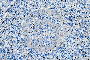 Extreme close up of decorative quartz sand epoxy floor or wall coating with blue, grey, white and black coloured particles