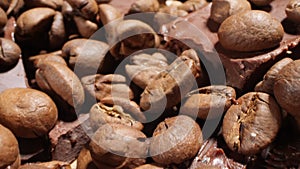 Extreme close-up of detailed coffee beans and bittersweet chocolate chunks with whole hazelnuts