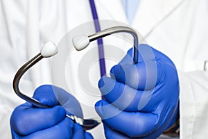 Extreme close-up of doctor's hands holding stethoscope