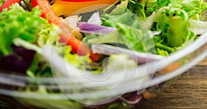 Extreme close-up of fresh vegetable salad in glass bowl on table