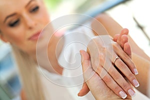 Extreme close up of girls hand with engagement ring.