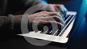 Extreme close-up hands of unrecognizable hacker programmer working typing on keyboard laptop.