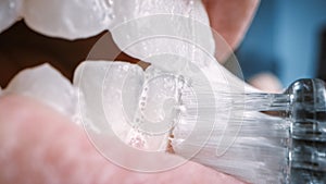 Extreme Close Up Macro Shot of a Person Brushing White Teeth. Whitening Toothpaste is Us