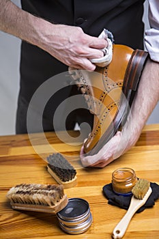 Extreme Close Up of Mans Hands Cleaning Luxury Calf Leather Brogues