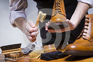 Extreme Close Up of Mans Hands Cleaning Luxury Calf Leather Brogues