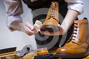 Extreme Close Up of Mans Hands Cleaning Luxury Calf Leather Brogues with Special Accessories