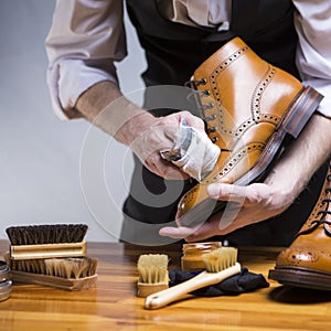 Extreme Close Up of Mans Hands Cleaning Luxury Calf Leather Brogues with Special Cloth