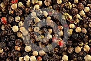Extreme close up of multicolored peppercorn mix. Macro texture food background