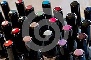 Extreme close up of nail polish bottles black lids with coloured