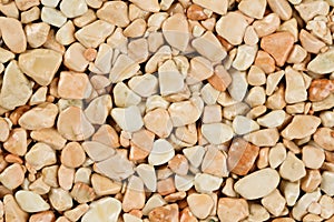 Extreme close up natural stone carpet, beige and cream coloured in different shades and tints of beige. Decorative stone coating.