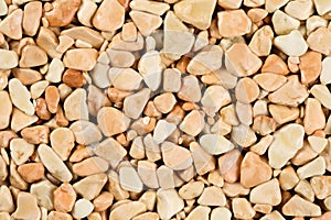 Extreme close up natural stone carpet, beige and cream coloured in different shades and tints of beige. Decorative stone coating.