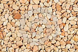 Extreme close up natural stone carpet, beige and cream coloured in different shades and tints of beige. Decorative stone coating.