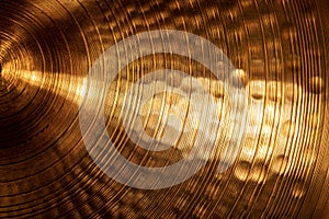 Extreme close-up of an old golden cymbal of drum kit photo