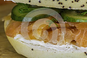 Extreme close-up of Seeded bagel with smoked salmon, cream cheese, cucumber, dill and capers