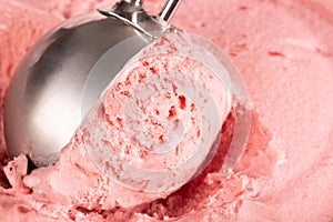 Extreme close up of strawberry ice cream being scooped