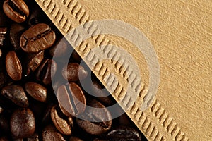 Extreme close up of texture of freshly roasted coffee beans and coffee cone filter from unbleached, recycled paper. Macro food