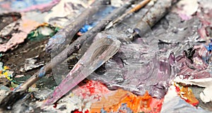 Extreme close up of thick wet oil paint on a palette