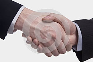 Extreme close up of two Businessmen shaking hands, studio shot