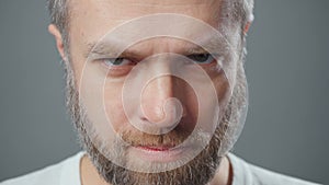 Extreme close up video of man looking frowningly