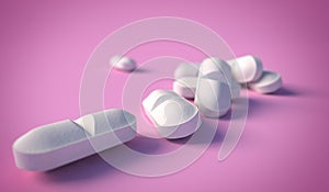 Extreme close-up of white medical tablets on pastel pink colored background