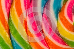 extreme closeup of colorful lollipop candy texture pattern on white background