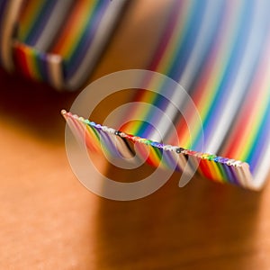 Extreme Closeup of Colorful Twisted Connecting Wire Strip on Plain Surface