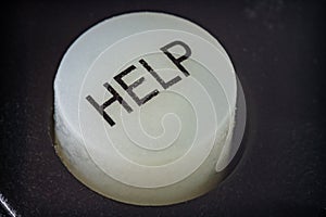 Extreme closeup of a help button on a remote