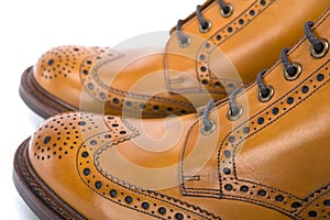 Extreme Closeup of Mens Tanned Brogue Leather Boots