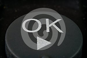 Extreme closeup of a ok button on TV remote