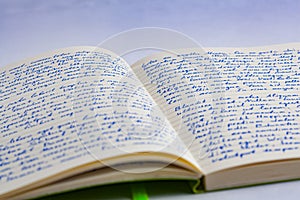 Extreme closeup of open notebook with handwritten lorem ipsum t