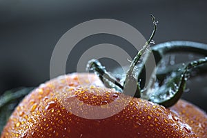 Extreme closeup of a wet ripe tomato. background of close up image of a fresh tomato with water droplets