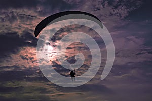 Extreme flying - paragliding at evening