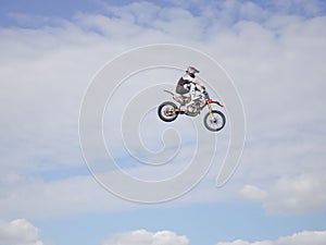 Extreme FMX stunt rider jumps high into the air