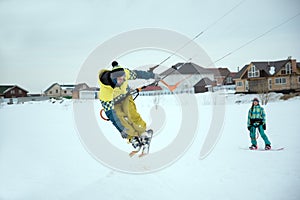 Extreme freestyle ski jump with young man at winter season. snowkiting.