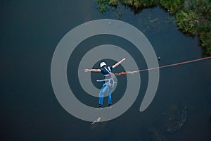 Extreme jump from the bridge. The man jumps surprisingly quickly in bungee jumping at Sky Park explores extreme fun. Bungee in the