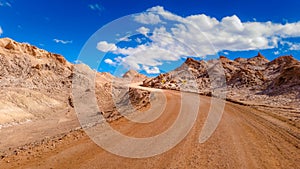 Extreme landscape, dirt road in the moon valley, at San Pedro de Atacama, Chile