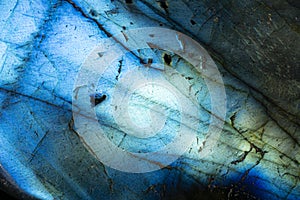 Extreme macro photo of a glowing blue labradorite stone.