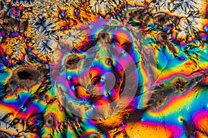 Extreme macro photograph of Vitamin C crystals forming abstract modern art patterns, when illuminated with polarized