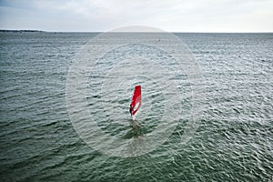 extreme man athlete swims on the wind surf on the sea wave against the blue sea and the horizon. Extreme water sports. movement of