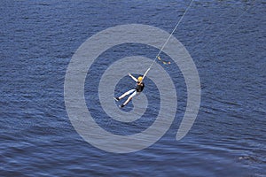 An extreme man jumps on a rope from a great height. Ropejumping